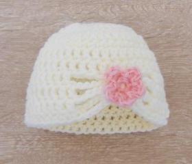 Crochet white baby hat with flower